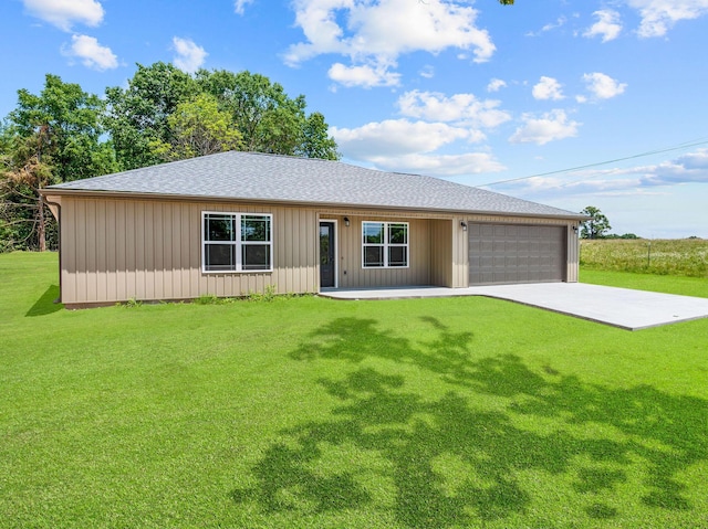 265 Mccann Rd, Powersite, MO 65731 - ranch-style home featuring a front lawn, a shingled roof, an attached garage, and driveway
