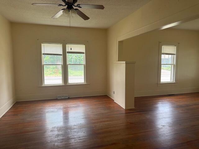 714 W Leyda Ave, West Plains, MO 65775 - unfurnished room with dark wood-type flooring, a ceiling fan, and a textured ceiling