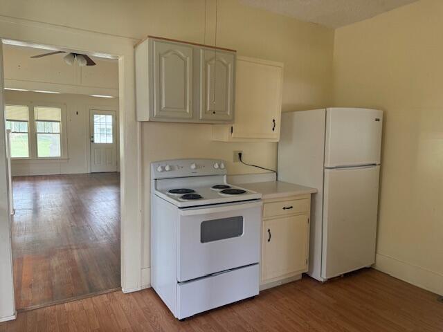 714 W Leyda Ave, West Plains, MO 65775 - kitchen with white appliances, ceiling fan, and light wood finished floors
