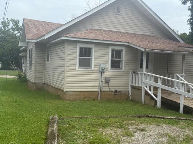 714 W Leyda Ave, West Plains, MO 65775 - view of property exterior featuring roof with shingles and a lawn