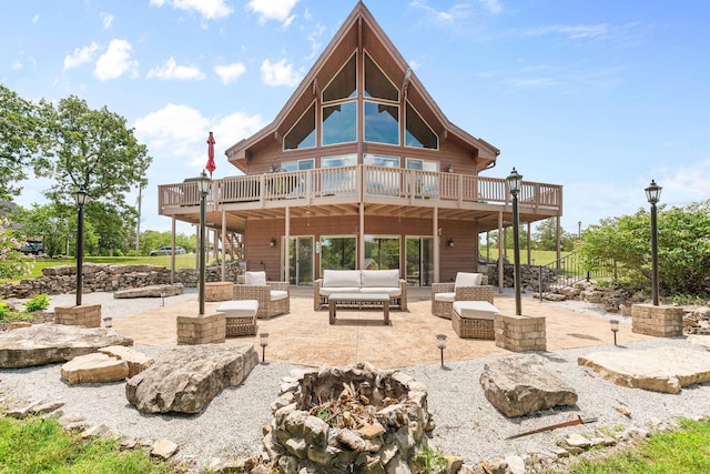 78 Free Bird Ln, Reeds Spring, MO 65737 - rear view of house featuring a patio area, an outdoor living space with a fire pit, and a deck