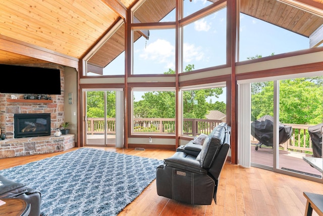 78 Free Bird Ln, Reeds Spring, MO 65737 - living room featuring high vaulted ceiling, plenty of natural light, a stone fireplace, wood finished floors, and wooden ceiling
