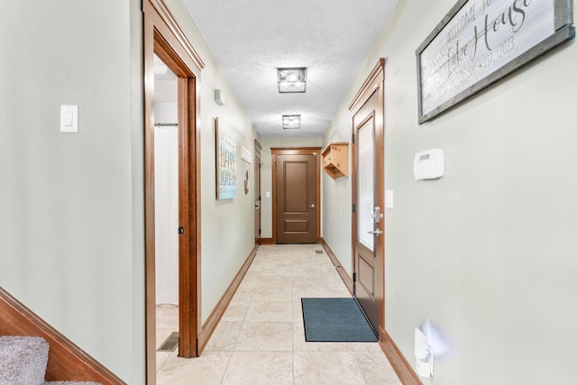 78 Free Bird Ln, Reeds Spring, MO 65737 - hallway with a textured ceiling and light tile patterned floors