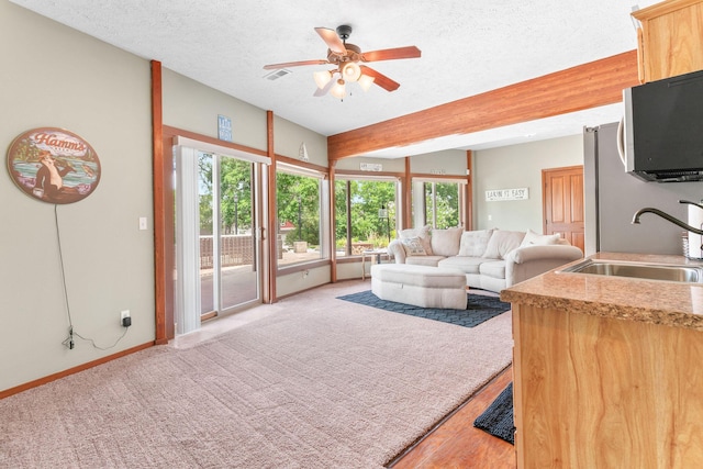 78 Free Bird Ln, Reeds Spring, MO 65737 - living area with ceiling fan, a textured ceiling, and beam ceiling