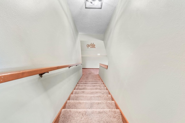 78 Free Bird Ln, Reeds Spring, MO 65737 - stairway featuring a textured ceiling and baseboards
