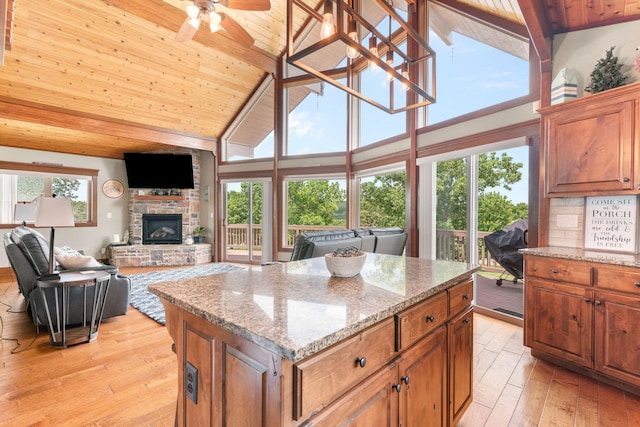 78 Free Bird Ln, Reeds Spring, MO 65737 - kitchen with a wood ceiling with exposed beams, high vaulted ceiling, light wood-style floors, ceiling fan, and a stone fireplace