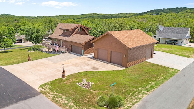 78 Free Bird Ln, Reeds Spring, MO 65737 - view of front of home with a wooded view, a front lawn, a detached garage, and roof with shingles