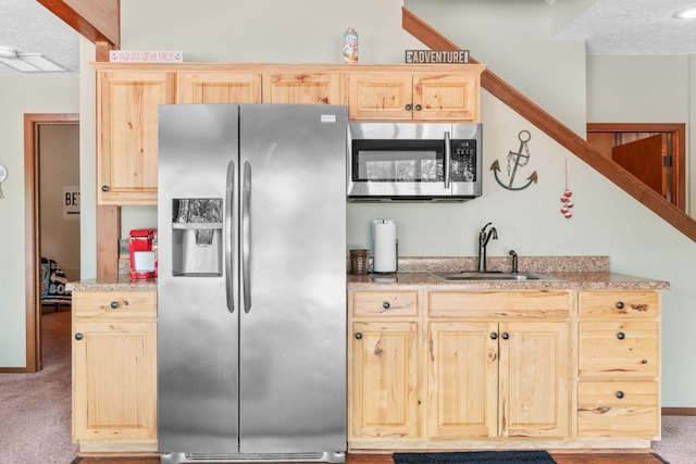 78 Free Bird Ln, Reeds Spring, MO 65737 - kitchen with appliances with stainless steel finishes, light brown cabinetry, carpet flooring, and a textured ceiling
