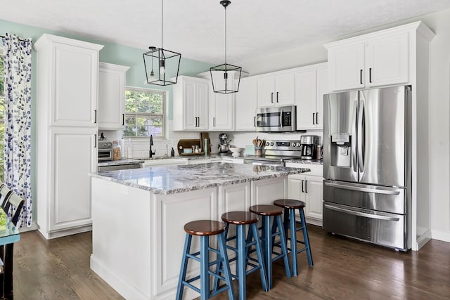4050 W Page Pl, Springfield, MO 65802 - kitchen featuring stainless steel appliances, dark wood finished floors, and white cabinets