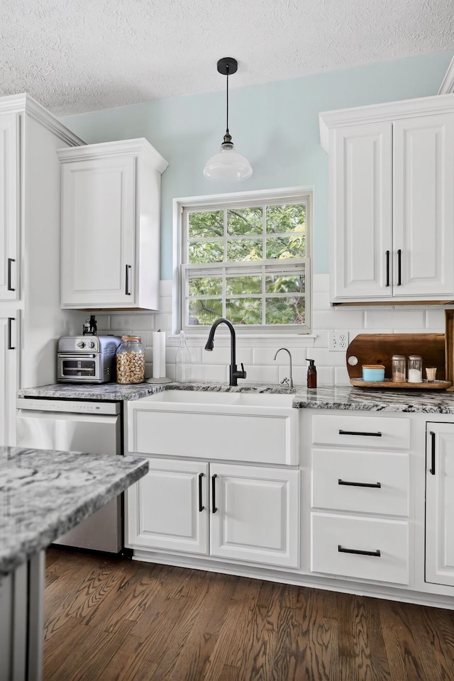 4050 W Page Pl, Springfield, MO 65802 - kitchen with dishwasher, white cabinets, a textured ceiling, and tasteful backsplash