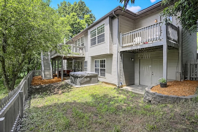 4050 W Page Pl, Springfield, MO 65802 - back of house featuring a hot tub, a fenced backyard, a deck, and stairs