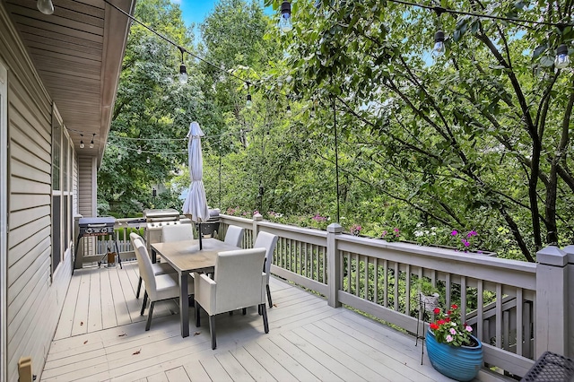 4050 W Page Pl, Springfield, MO 65802 - deck featuring outdoor dining area, grilling area, and view of wooded area