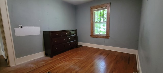 1305 S Kimbrough Ave, Springfield, MO 65807 - unfurnished bedroom featuring wood finished floors and baseboards