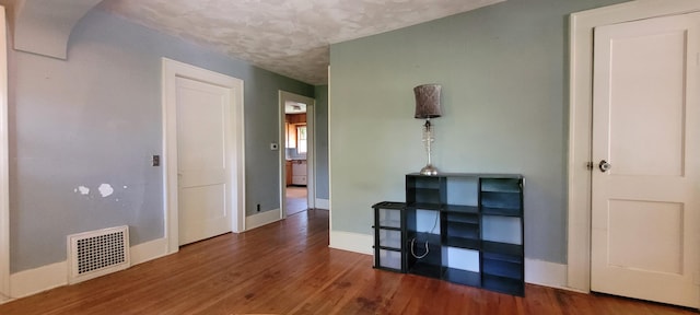 1305 S Kimbrough Ave, Springfield, MO 65807 - spare room featuring wood finished floors and a textured ceiling