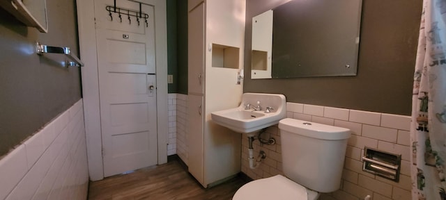 1305 S Kimbrough Ave, Springfield, MO 65807 - bathroom featuring tile walls, wainscoting, and wood finished floors