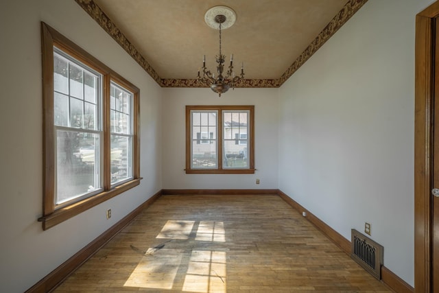 400 S Jefferson St, Neosho, MO 64850 - empty room featuring a chandelier and wood finished floors
