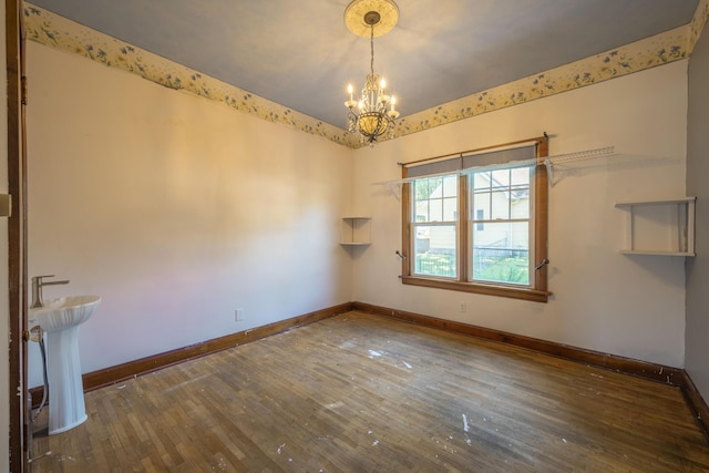 400 S Jefferson St, Neosho, MO 64850 - spare room with a chandelier and hardwood / wood-style flooring