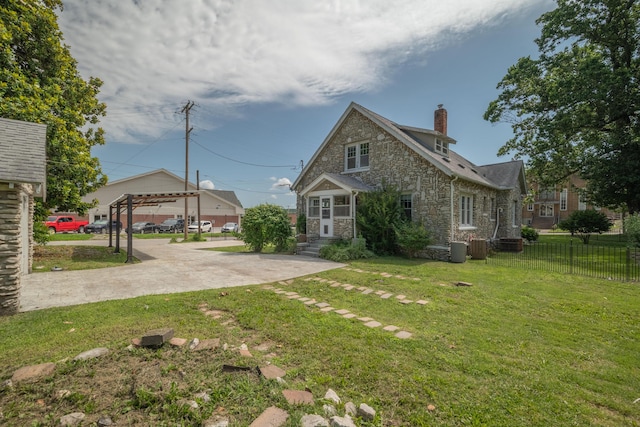400 S Jefferson St, Neosho, MO 64850 - view of property exterior featuring stone siding and a chimney
