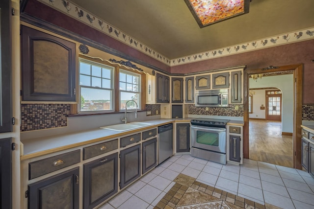 400 S Jefferson St, Neosho, MO 64850 - kitchen with stainless steel appliances, light tile patterned floors, tasteful backsplash, and light countertops
