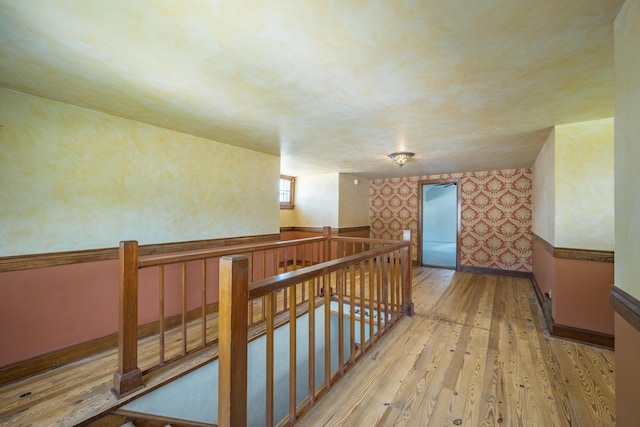400 S Jefferson St, Neosho, MO 64850 - corridor featuring an upstairs landing, wallpapered walls, and hardwood / wood-style floors