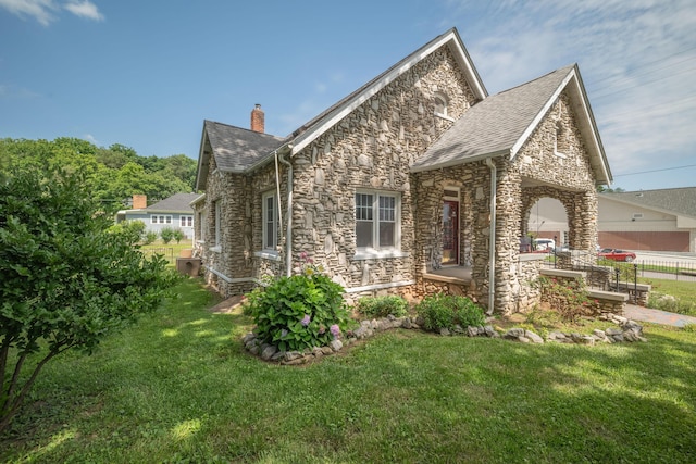 400 S Jefferson St, Neosho, MO 64850 - view of side of property featuring stone siding, a chimney, and a yard
