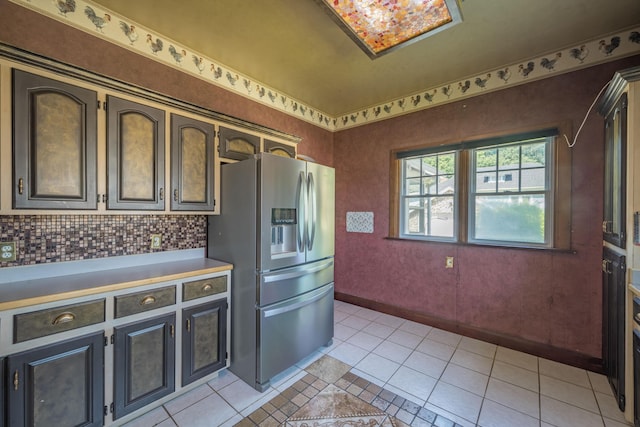 400 S Jefferson St, Neosho, MO 64850 - kitchen featuring stainless steel fridge with ice dispenser, light tile patterned flooring, light countertops, and backsplash