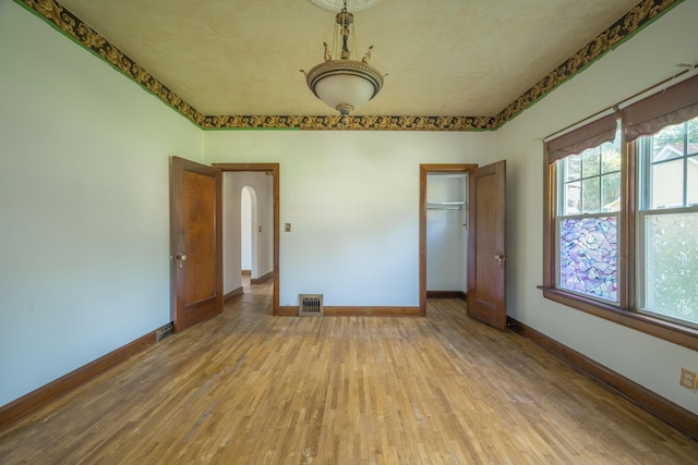 400 S Jefferson St, Neosho, MO 64850 - spare room with hardwood / wood-style floors and arched walkways