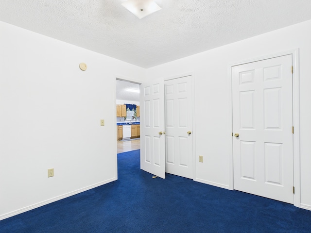 1007 S Walnut St, Harrison, AR 72601 - unfurnished bedroom with dark carpet and a textured ceiling