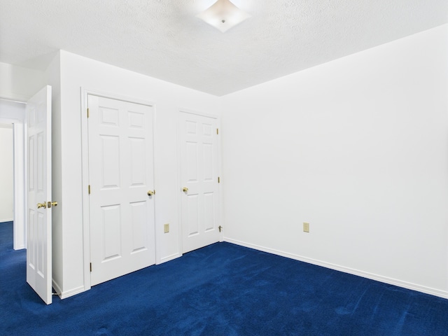 1007 S Walnut St, Harrison, AR 72601 - unfurnished bedroom featuring dark colored carpet and a textured ceiling