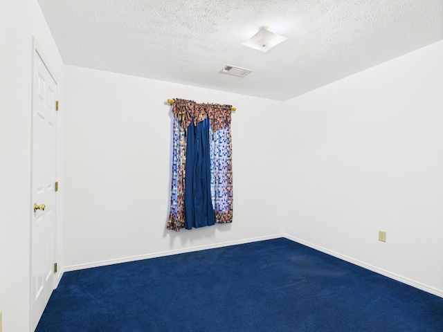 1007 S Walnut St, Harrison, AR 72601 - spare room with dark colored carpet and a textured ceiling