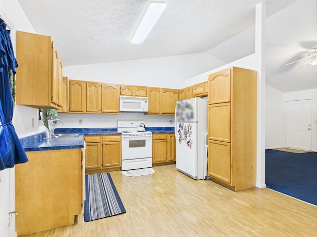 1007 S Walnut St, Harrison, AR 72601 - kitchen featuring white appliances, vaulted ceiling, dark countertops, light wood finished floors, and a textured ceiling