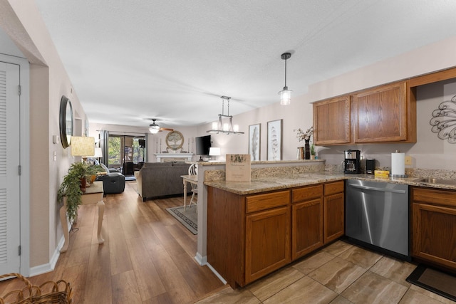 366 Wimbledon Dr Unit 4, Branson, MO 65616 - kitchen with dishwasher, a peninsula, brown cabinetry, and open floor plan