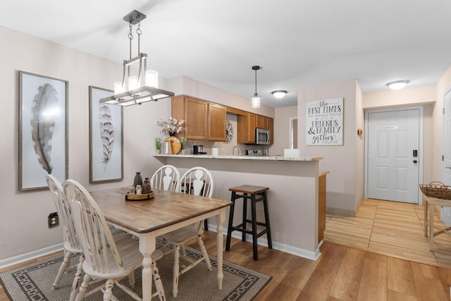 366 Wimbledon Dr Unit 4, Branson, MO 65616 - dining space with baseboards and light wood-style flooring