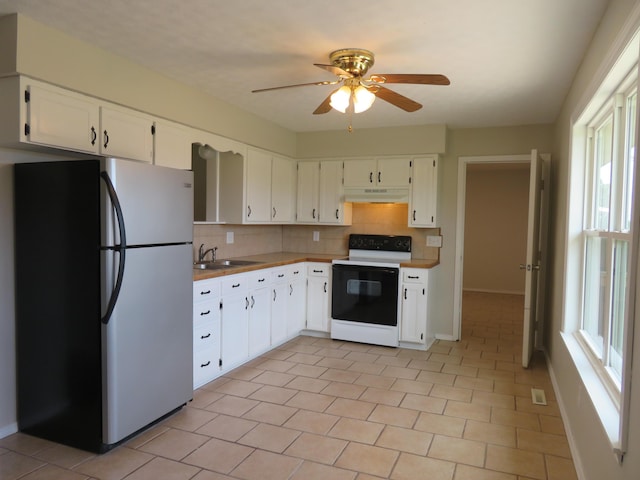 1007 E Parkview St, Ozark, MO 65721 - kitchen featuring freestanding refrigerator, electric range, under cabinet range hood, decorative backsplash, and white cabinets