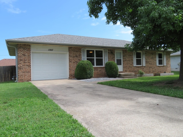 1007 E Parkview St, Ozark, MO 65721 - single story home with brick siding, driveway, an attached garage, and roof with shingles