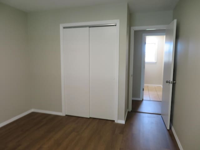 1007 E Parkview St, Ozark, MO 65721 - unfurnished bedroom with wood finished floors and a closet