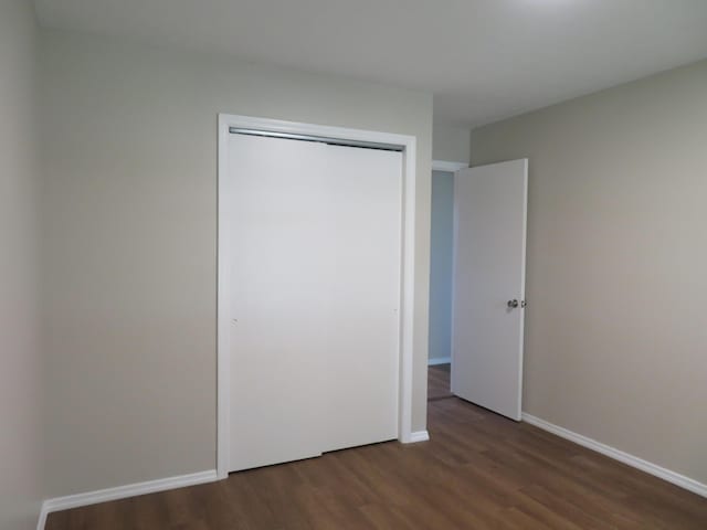 1007 E Parkview St, Ozark, MO 65721 - unfurnished bedroom with wood finished floors and a closet
