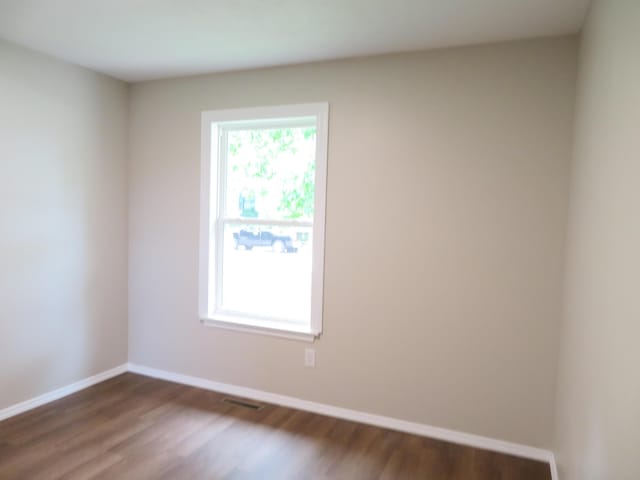 1007 E Parkview St, Ozark, MO 65721 - spare room with dark wood-type flooring and baseboards