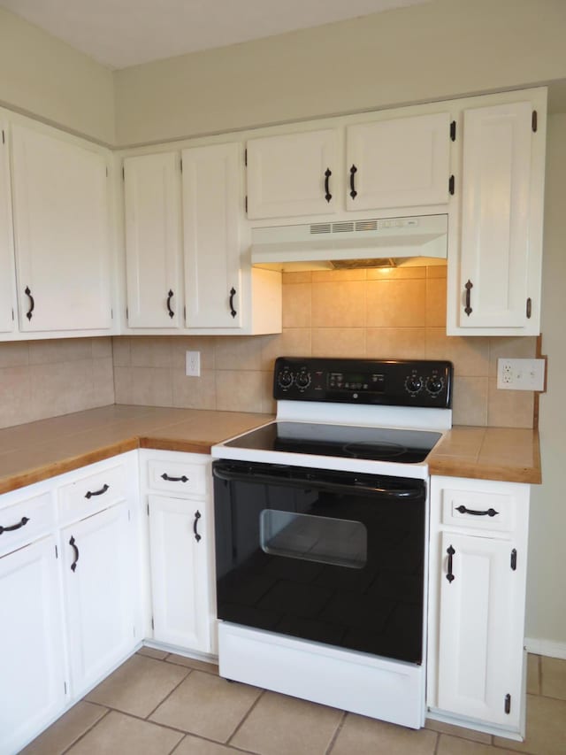 1007 E Parkview St, Ozark, MO 65721 - kitchen featuring white range with electric cooktop, under cabinet range hood, white cabinetry, and decorative backsplash