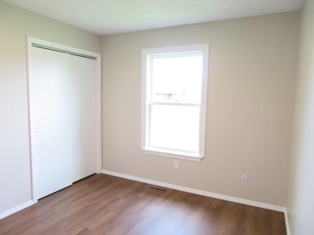 1007 E Parkview St, Ozark, MO 65721 - unfurnished bedroom featuring wood finished floors and a closet