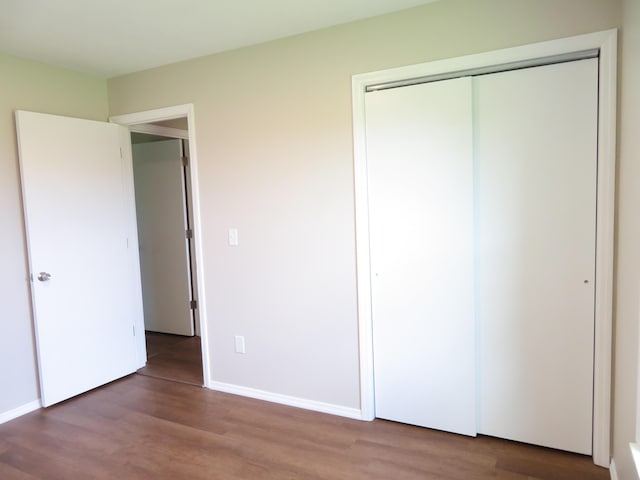 1007 E Parkview St, Ozark, MO 65721 - unfurnished bedroom with wood finished floors and a closet