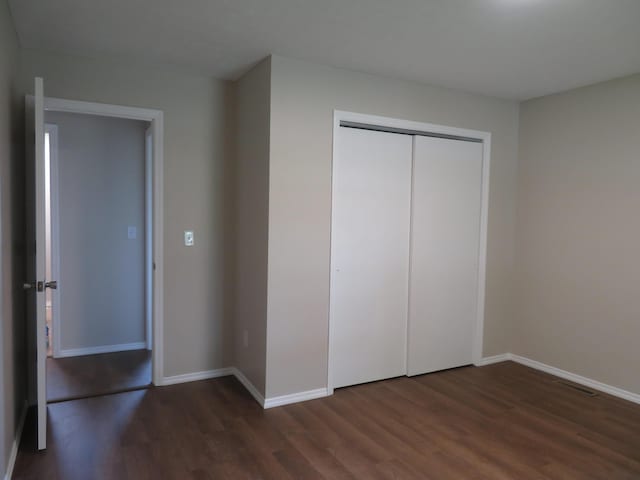 1007 E Parkview St, Ozark, MO 65721 - unfurnished bedroom featuring dark wood-style floors and a closet