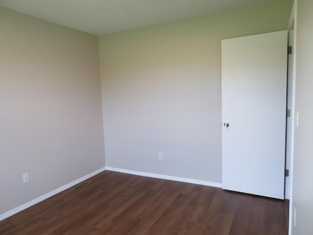 1007 E Parkview St, Ozark, MO 65721 - spare room featuring dark wood-style flooring and baseboards