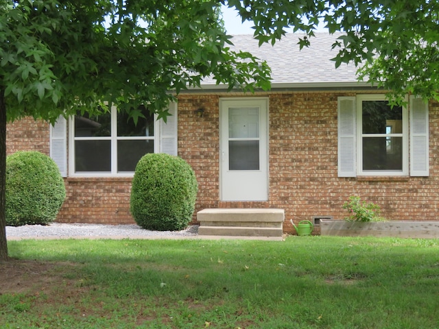 1007 E Parkview St, Ozark, MO 65721 - view of front of house featuring brick siding, entry steps, a front lawn, and a shingled roof