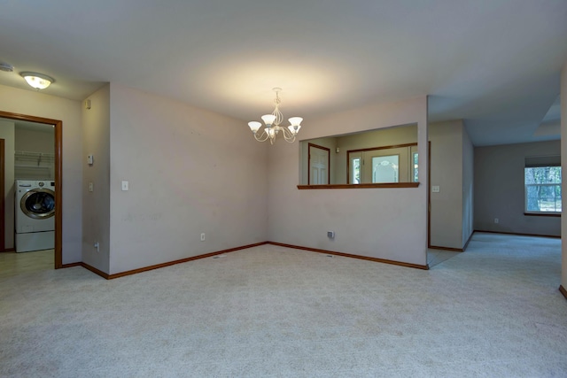 1030 Harris Blvd, Ozark, MO 65721 - carpeted empty room with washer / clothes dryer and a chandelier