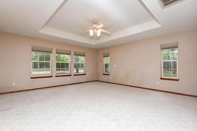 1030 Harris Blvd, Ozark, MO 65721 - carpeted empty room featuring a tray ceiling, ceiling fan, and healthy amount of natural light