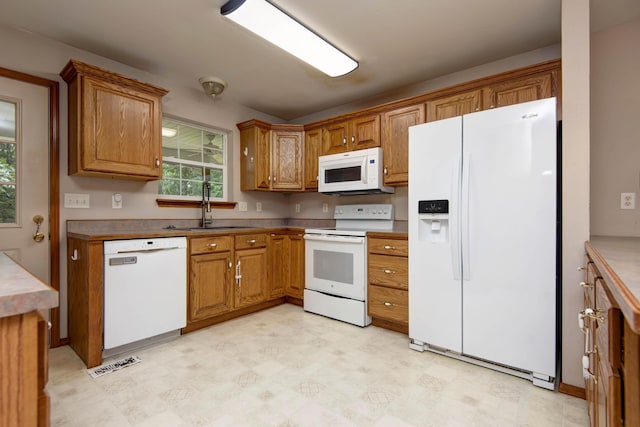 1030 Harris Blvd, Ozark, MO 65721 - kitchen with white appliances, brown cabinets, and light floors