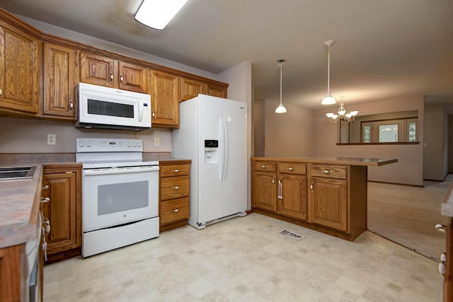 1030 Harris Blvd, Ozark, MO 65721 - kitchen featuring white appliances, brown cabinetry, and a peninsula