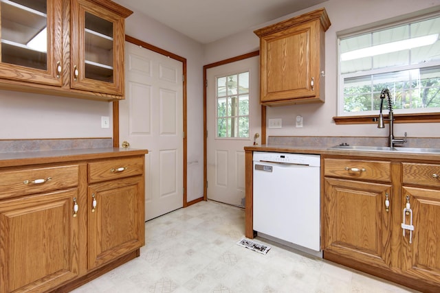 1030 Harris Blvd, Ozark, MO 65721 - kitchen featuring white dishwasher, healthy amount of natural light, light floors, and brown cabinets
