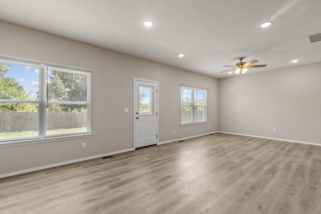 200 E Rosalie St, Strafford, MO 65757 - unfurnished living room with a ceiling fan, light wood finished floors, recessed lighting, and a textured ceiling